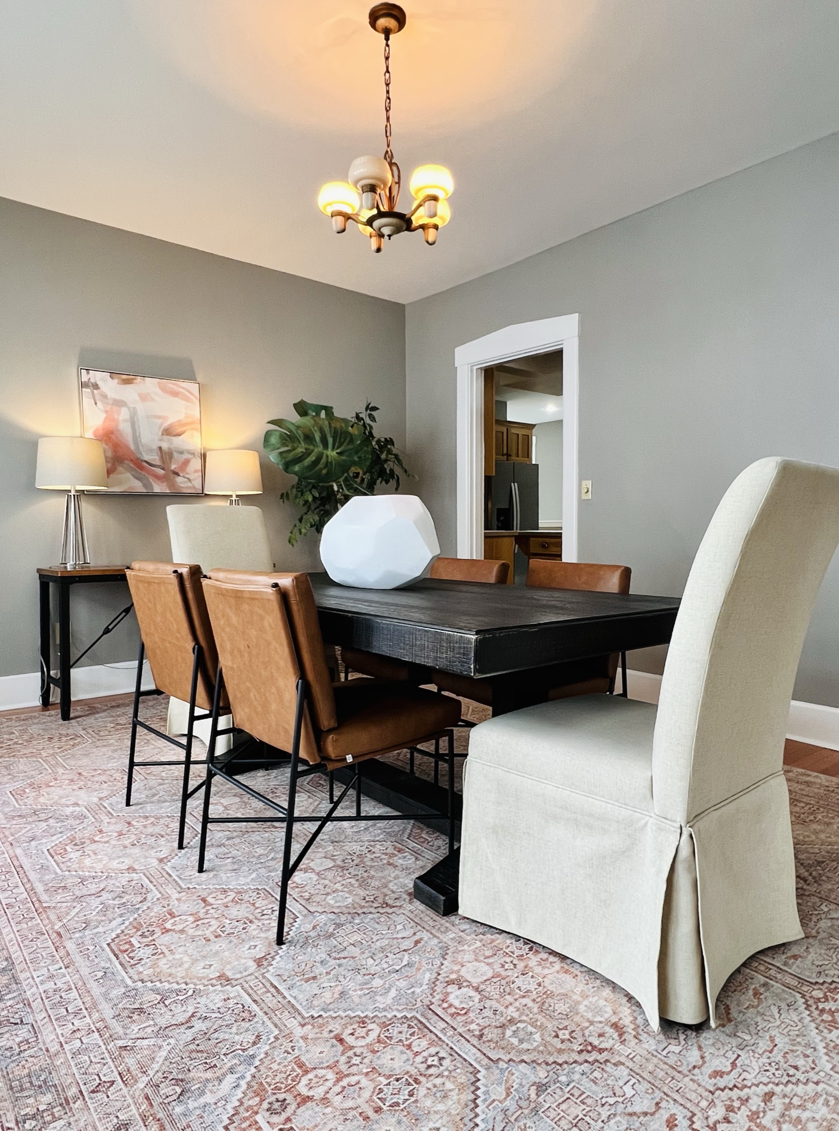 Dining room table with neutral walls and white trim