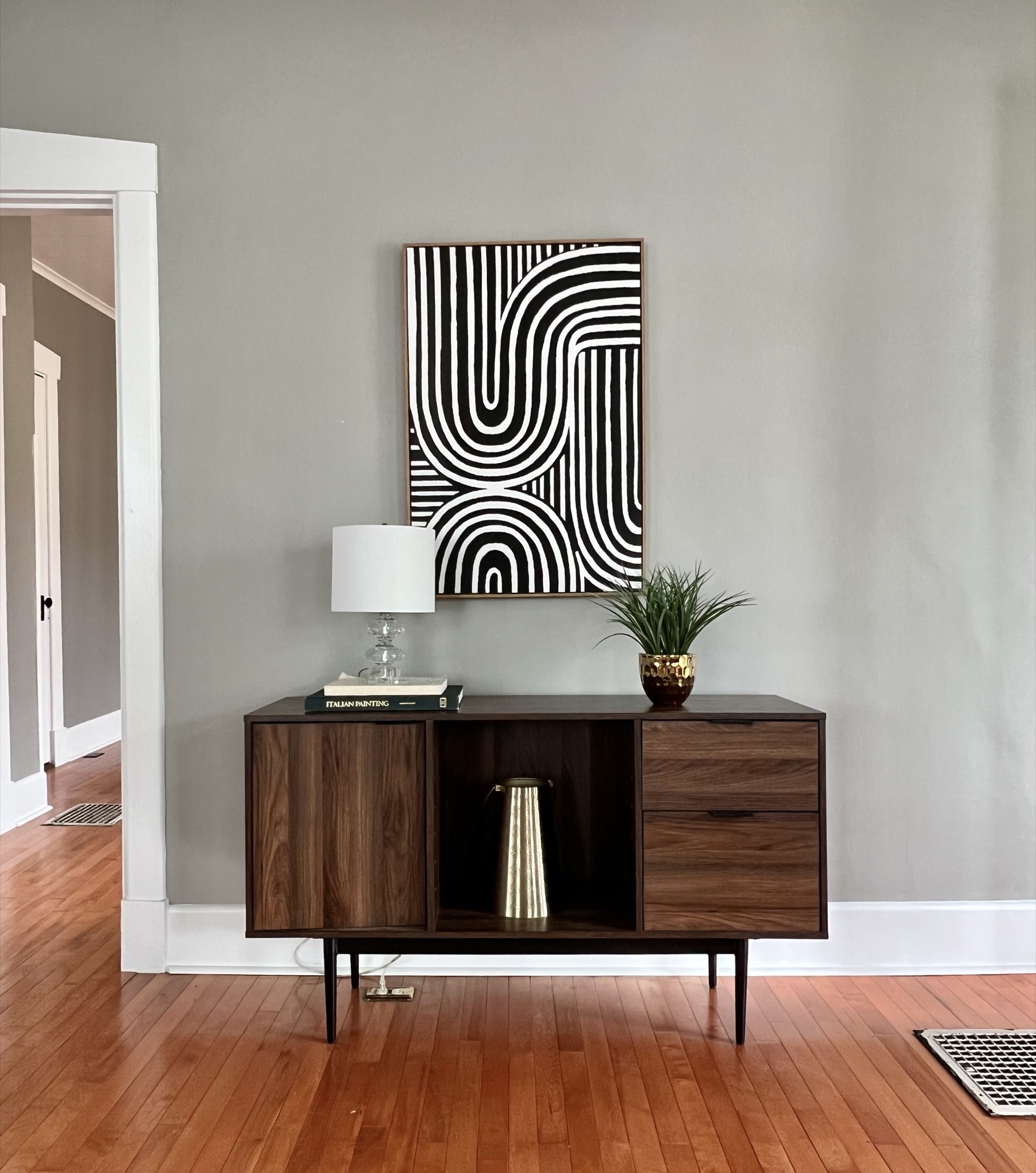Hardwood floor detail with console table and artwork